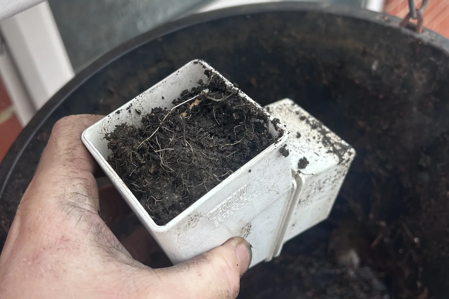 A swan-neck bend taken off the downpipe, packed solid with silt