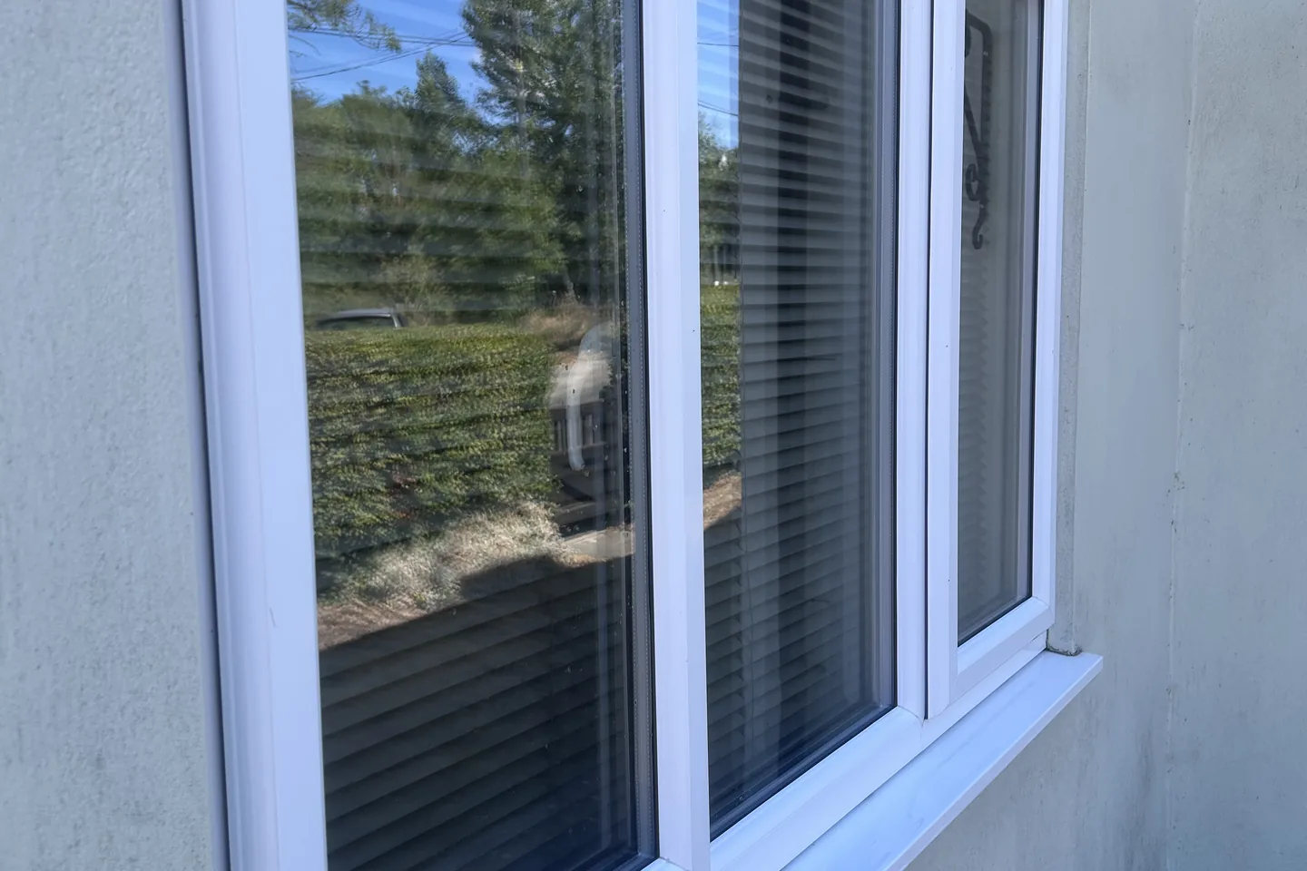 Cleaned uPVC windows in a rendered wall
