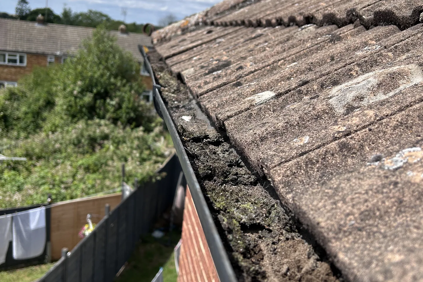 The same style of gutter run cleared out, seen along the roofline