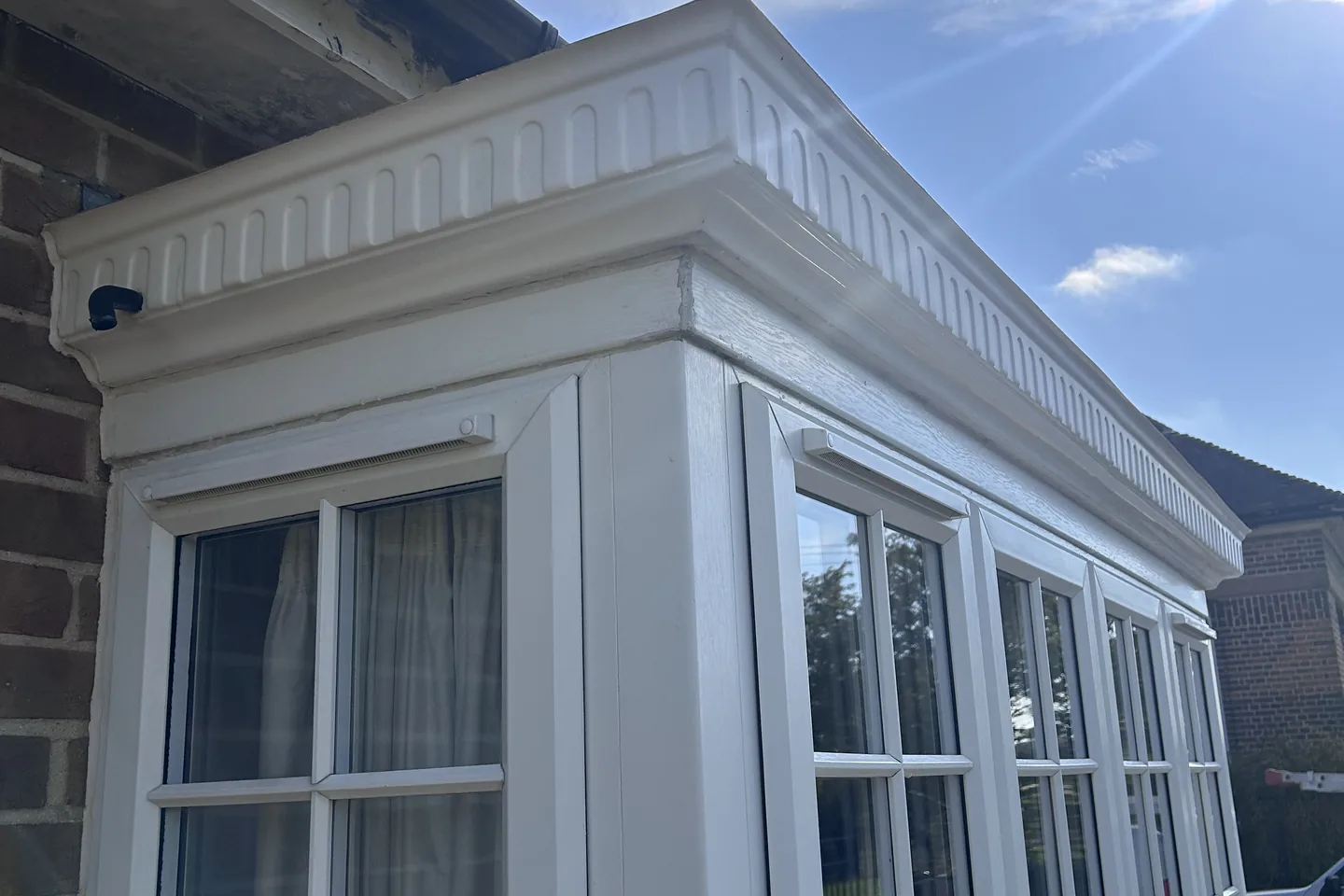 The same fascia and soffit corner back to white after a soft wash