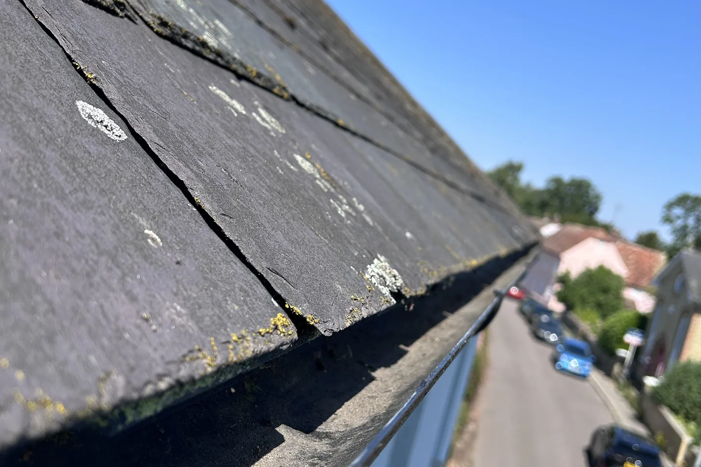 The same gutter channel from the same angle, cleared back to the metal